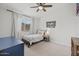 Cozy bedroom with a bright window, a comfortable bed, and a vaulted ceiling at 7701 E Portobello Ave, Mesa, AZ 85212