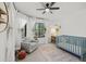 Bright Bedroom with large window, chair, and blue crib at 7701 E Portobello Ave, Mesa, AZ 85212