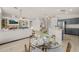 Dining area features a glass table, seating for four, and seamless flow into the kitchen and living room at 7701 E Portobello Ave, Mesa, AZ 85212