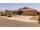 Single-story house with low-maintenance landscape, a two-car garage, and a charming entrance at 7701 E Portobello Ave, Mesa, AZ 85212