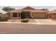 Charming single-story home with a well-manicured, low-maintenance desert landscape and tile roof at 7701 E Portobello Ave, Mesa, AZ 85212
