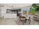 Eat-in kitchen boasts dark gray cabinets, stainless appliances, and natural light from multiple windows at 7701 E Portobello Ave, Mesa, AZ 85212