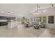 Open-concept living space with a modern kitchen, dining area, and cozy seating area at 7701 E Portobello Ave, Mesa, AZ 85212