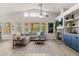 Bright living room with vaulted ceilings, stone fireplace, comfortable seating, and natural light at 7701 E Portobello Ave, Mesa, AZ 85212