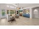 Bright living room featuring vaulted ceilings, stone fireplace, built-in shelving, and comfortable seating at 7701 E Portobello Ave, Mesa, AZ 85212