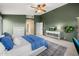 Bright main bedroom with high ceilings, green accent wall, and access to the en-suite bathroom at 7701 E Portobello Ave, Mesa, AZ 85212