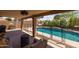 Covered patio area overlooking backyard swimming pool with fence at 7701 E Portobello Ave, Mesa, AZ 85212