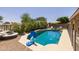 Swimming pool with basketball hoop surrounded by mature landscaping at 7701 E Portobello Ave, Mesa, AZ 85212