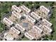 Aerial view of the community showcasing multiple residential buildings, lush landscaping, and amenities at 7960 E Camelback Rd # 109, Scottsdale, AZ 85251