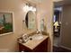 Bathroom vanity with granite countertop, round mirror, and brushed nickel faucet at 7960 E Camelback Rd # 109, Scottsdale, AZ 85251