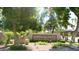 Scottsdale Shadows condominium community sign surrounded by lush trees and greenery at 7960 E Camelback Rd # 109, Scottsdale, AZ 85251