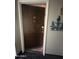 View of front door entryway, leading into a hallway with a mirrored closet and wood-look tile flooring at 7960 E Camelback Rd # 109, Scottsdale, AZ 85251