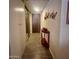 Bright hallway features wood-look tile flooring, decorative wall art and access to multiple closets at 7960 E Camelback Rd # 109, Scottsdale, AZ 85251