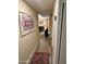 Hallway leading to dining room and kitchen with area rug and artwork at 7960 E Camelback Rd # 109, Scottsdale, AZ 85251