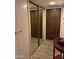 View of hallway with mirrored closet, stylish wood-look tile flooring and access to the front door at 7960 E Camelback Rd # 109, Scottsdale, AZ 85251