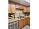 Kitchen sink area with stainless steel appliances, granite counters and wood cabinets at 7960 E Camelback Rd # 109, Scottsdale, AZ 85251
