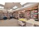Cozy library featuring extensive bookshelves, comfortable seating, and a table for games and puzzles at 7960 E Camelback Rd # 109, Scottsdale, AZ 85251