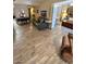 Spacious living room features wood-look tile flooring, piano and comfortable seating at 7960 E Camelback Rd # 109, Scottsdale, AZ 85251