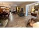 Spacious open-concept living area with wood-look tile flooring connecting the kitchen and dining spaces at 7960 E Camelback Rd # 109, Scottsdale, AZ 85251