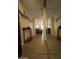 Open entryway with wood-look tile flooring leading into a spacious living room with stylish decor at 7960 E Camelback Rd # 109, Scottsdale, AZ 85251