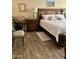 Comfortable main bedroom featuring a wooden bed frame, neutral bedding, and southwestern-themed decor at 7960 E Camelback Rd # 109, Scottsdale, AZ 85251