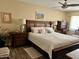 Spacious main bedroom with wood flooring, desert-themed wall art, and stylish wooden furniture at 7960 E Camelback Rd # 109, Scottsdale, AZ 85251