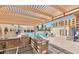 Stunning pool area with outdoor kitchen, pergola, lounge chairs, and dining; perfect for entertaining at 7960 E Camelback Rd # 109, Scottsdale, AZ 85251
