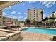 Inviting pool area with lounge chairs, tables, and umbrellas for a relaxing outdoor experience at 7960 E Camelback Rd # 109, Scottsdale, AZ 85251
