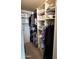 Organized walk-in closet with shelving and hanging rods for efficient storage of clothing and accessories at 7960 E Camelback Rd # 109, Scottsdale, AZ 85251