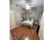 Cozy bedroom features hardwood floors, a mirrored closet, and a light-filled window at 8245 E Bell Rd # 103, Scottsdale, AZ 85260