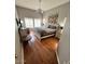 Bright and airy main bedroom with hardwood floors, ceiling fan, and large windows at 8245 E Bell Rd # 103, Scottsdale, AZ 85260