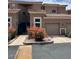 Well-maintained exterior of a multi-unit home with a garage and vibrant flowering bushes adding curb appeal at 8245 E Bell Rd # 103, Scottsdale, AZ 85260