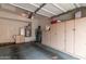 Spacious garage with storage cabinets, water heater, and garage door opener at 8245 E Bell Rd # 103, Scottsdale, AZ 85260