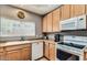 Bright kitchen with wood cabinets, modern appliances, and a view from the window at 8245 E Bell Rd # 103, Scottsdale, AZ 85260