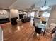 Open-concept living room boasts hardwood floors, fireplace, and sliding glass doors to an outdoor patio at 8245 E Bell Rd # 103, Scottsdale, AZ 85260
