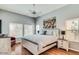 Serene main bedroom with natural light, hardwood floors, and a ceiling fan at 8245 E Bell Rd # 103, Scottsdale, AZ 85260