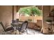 Outdoor patio with seating and a view of the surrounding greenery at 8245 E Bell Rd # 103, Scottsdale, AZ 85260