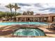 Community pool with spa, lounge chairs, and covered area with seating at 8245 E Bell Rd # 103, Scottsdale, AZ 85260