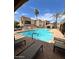 Community pool with lounge chairs and shaded seating areas, offering a relaxing oasis for residents to enjoy at 8245 E Bell Rd # 103, Scottsdale, AZ 85260