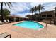 Inviting community pool surrounded by palm trees and seating areas, creating a resort-style atmosphere for residents at 8245 E Bell Rd # 103, Scottsdale, AZ 85260
