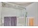 Contemporary shower with glass enclosure, and white tile at 8245 E Bell Rd # 103, Scottsdale, AZ 85260