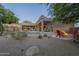 Inviting backyard with stone fire pit, outdoor seating, and built in patio bar at 8248 E Arroyo Hondo Rd, Scottsdale, AZ 85266