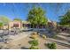 Desert landscaping in backyard including pool, spa, seating, and covered patio with outdoor kitchen at 8248 E Arroyo Hondo Rd, Scottsdale, AZ 85266