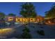 Expansive backyard view featuring the pool, covered patio, desert landscaping, and outdoor seating at 8248 E Arroyo Hondo Rd, Scottsdale, AZ 85266