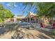 Private backyard featuring pool, seating, outdoor kitchen, fire pit, desert landscaping and mountain views at 8248 E Arroyo Hondo Rd, Scottsdale, AZ 85266