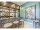 Custom bar with unique lighting and elegant mosaic tile at 8248 E Arroyo Hondo Rd, Scottsdale, AZ 85266