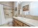 Classic bathroom with neutral tile, wood vanity, and decorative accents at 8248 E Arroyo Hondo Rd, Scottsdale, AZ 85266