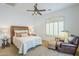 Cozy bedroom features a plush leather armchair, shuttered window, and comfortable queen-sized bed at 8248 E Arroyo Hondo Rd, Scottsdale, AZ 85266