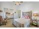 Bright bedroom boasts unique, carved wood bed frame, mirrored closet doors, and ceiling fan at 8248 E Arroyo Hondo Rd, Scottsdale, AZ 85266