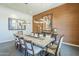 Cozy dining room with a rustic wooden table, upholstered chairs, and elegant wall art at 8248 E Arroyo Hondo Rd, Scottsdale, AZ 85266